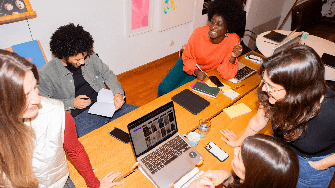 Team collaborating around a table on workflow and planning tasks
